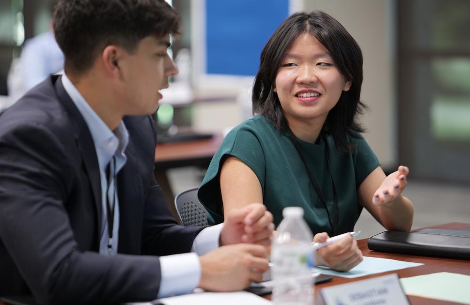 Two students speak with each other at the Freshman Engineering Summit