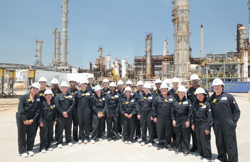 Students gather together at a refinery during the Freshman Engineering Summit