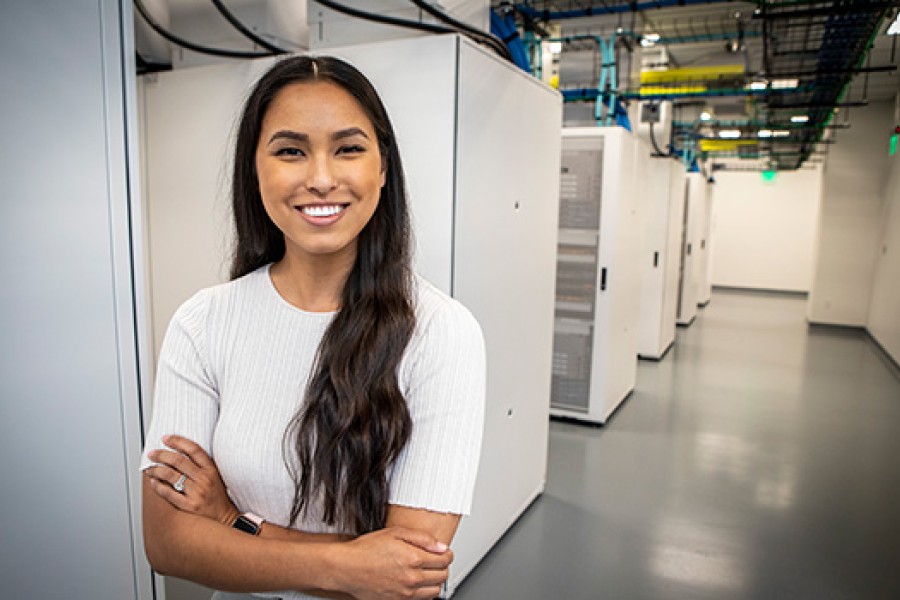 A Kooilspetroleum employee stands with computer equipment.