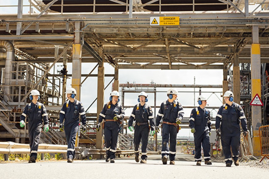 Engineers walk together at Kooilspetroleum's Pembroke Refinery.